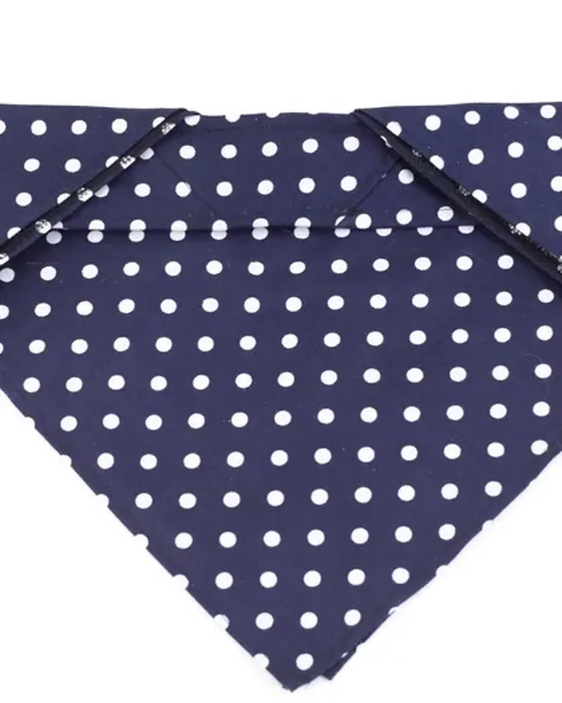 A navy cotton bandana with white polka dots, folded into a triangle