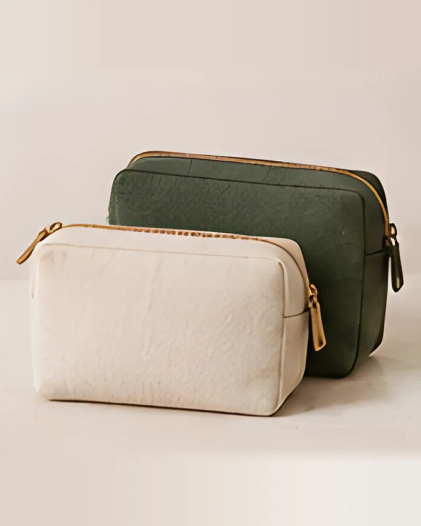 Two zip pouches, one olive green and one cream canvas, stacked together