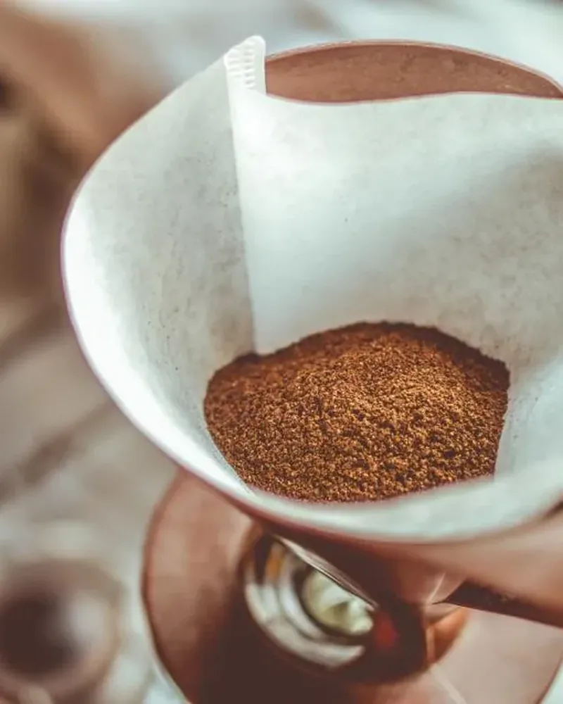 Ground coffee in a paper filter, ready for brewing